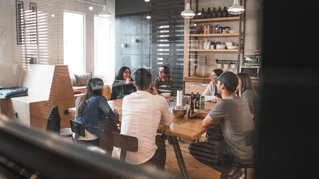 A group of professionals in a meeting discussing strategies, representing segmentation for effective communication.