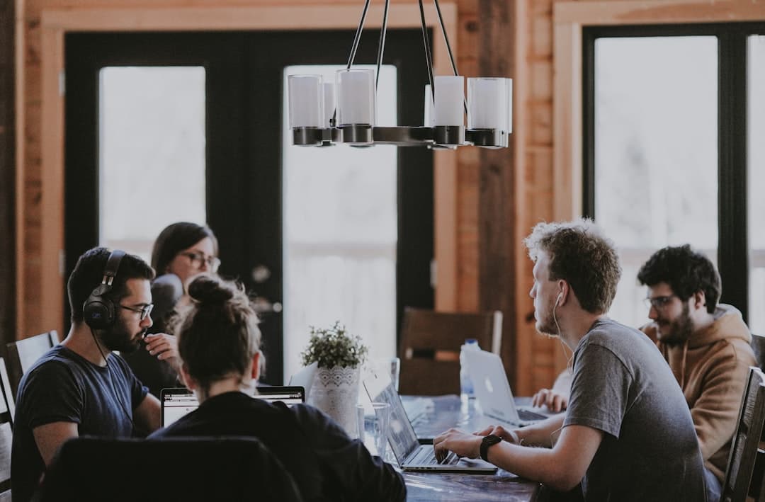 A diverse group of therapists collaborating in a meeting room, discussing strategies for choosing a therapy niche.