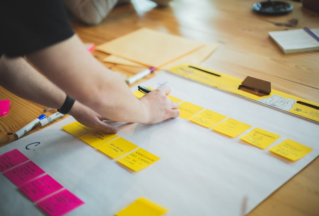 A therapist writing on a whiteboard, outlining a niche strategy plan to effectively market their therapy practice.