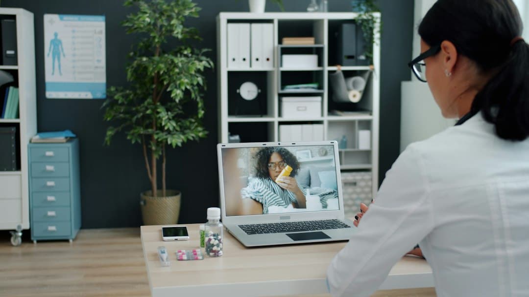 A telehealth setup with a computer and headset, illustrating technology integration in private practice.