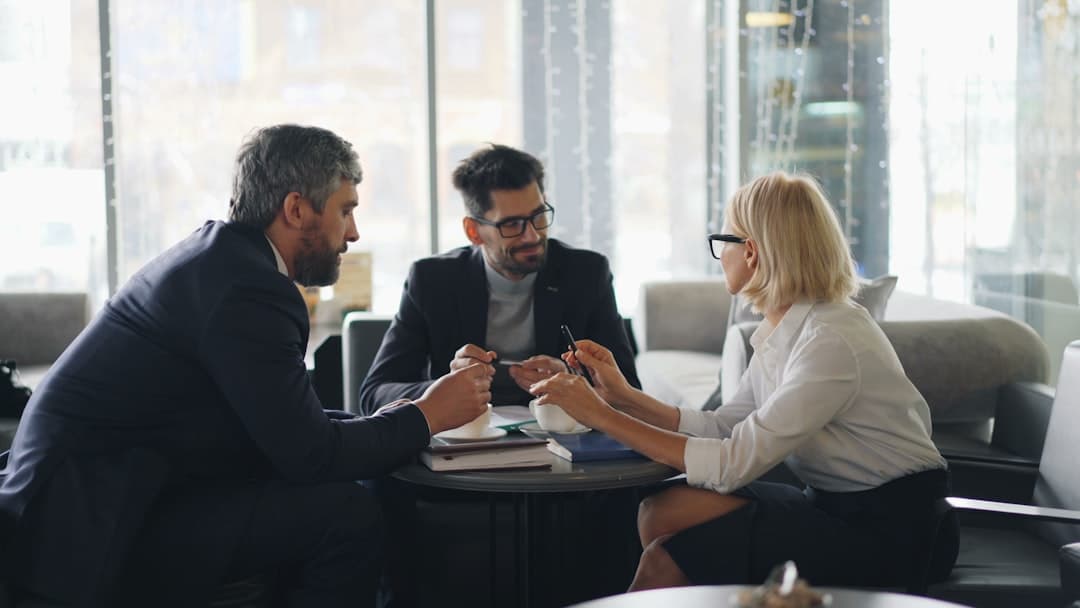 A group of professionals engaged in a networking meeting, illustrating strategic network building for therapists.