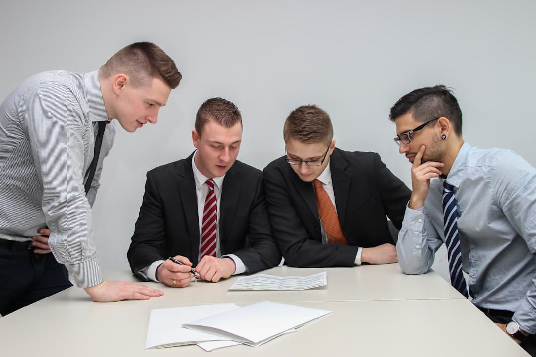 A professional consulting meeting in a modern office setting, showcasing a team discussing strategies for therapy practice growth.