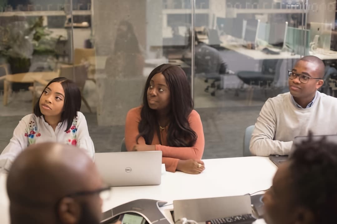 A group of healthcare professionals in a meeting, discussing strategies for setting therapy fees in a private practice