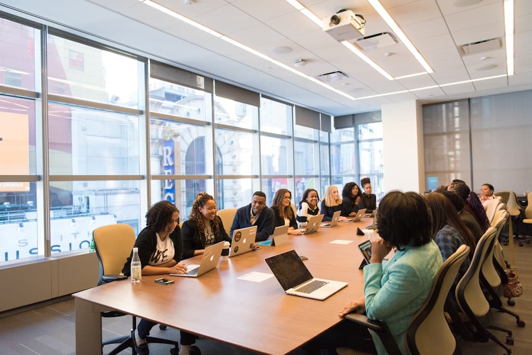 A diverse team of professionals in a meeting room discussing strategies, representing the consulting aspect of therapy practices.