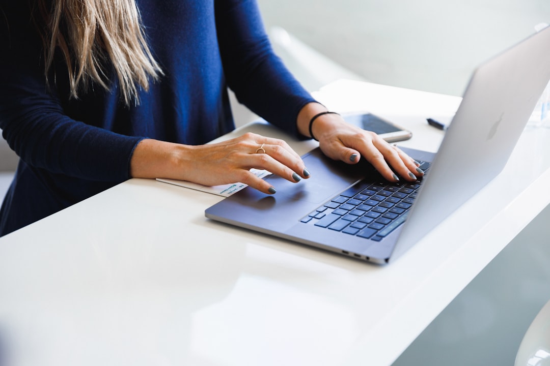 A therapist working on a laptop in a calm office setting, representing the use of Google Business Profile for therapists.
