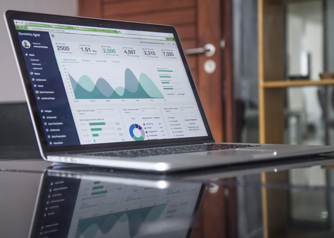 A person analyzing performance metrics on a laptop, highlighting the need to monitor Google Business Profile performance and adjust strategies.